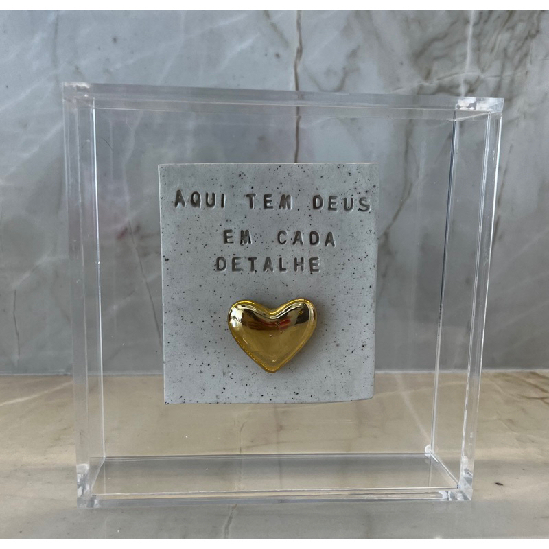 Quadro de Acrílico com placa de cerâmica “ Aqui tem Deus em cada detalhe ”. o modelo de coração pode variar
